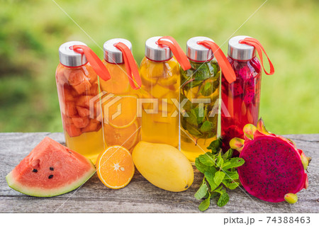 Cambucha with various fruits arranged in the form of a rainbow. Homemade fermented raw kombucha tea with different flavorings. Healthy natural probiotic flavored drink. LGBT Cambucha with various fruits arranged in the form of a rainbow. Homemade fermented raw kombucha tea with different flavorings. Healthy natural probiotic flavored drink. LGBT 74388463