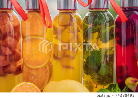 Cambucha with various fruits arranged in the form of a rainbow. Homemade fermented raw kombucha tea with different flavorings. Healthy natural probiotic flavored drink. LGBT Cambucha with various fruits arranged in the form of a rainbow. Homemade fermented raw kombucha tea with different flavorings. Healthy natural probiotic flavored drink. LGBT 74388495