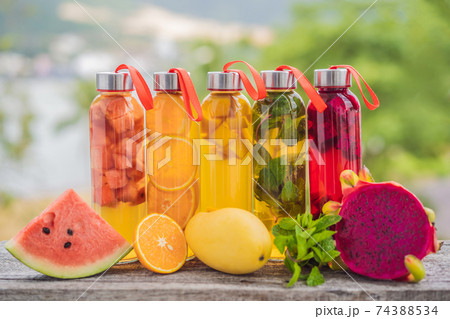 Cambucha with various fruits arranged in the form of a rainbow. Homemade fermented raw kombucha tea with different flavorings. Healthy natural probiotic flavored drink. LGBT 74388534