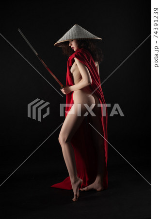 naked slender woman in a red cape and an Asian hat with a katana in her hand image of a samurai naked slender woman in a red cape and an Asian hat with a katana in her hand image of a samurai 74391239