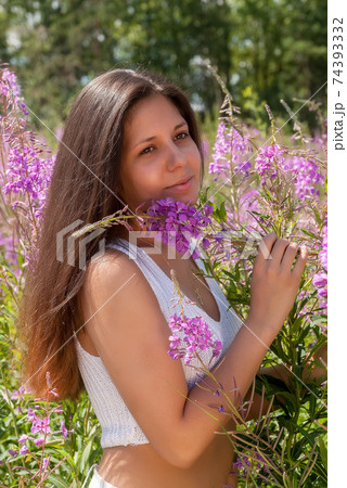 Portrait of young beautiful woman on fireweed meadow 74393332