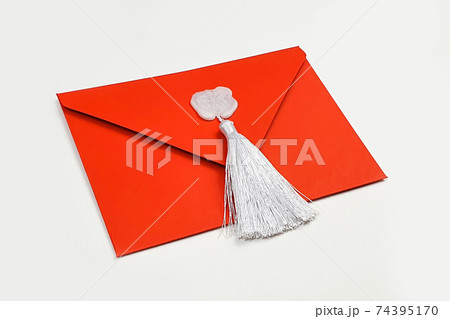 Red envelope with white wax stamp and silk tassel for gift certificate or invitation. Red envelope with white wax stamp and silk tassel for gift certificate or invitation. 74395170