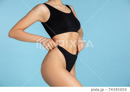Beautiful body of young caucasian woman isolated on blue studio background 74395850