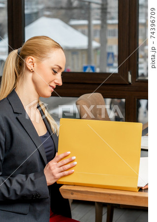 Young businesswoman looking at folder Young businesswoman looking at folder 74396709