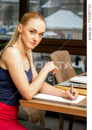 Business woman is writing documents Business woman is writing documents 74396710
