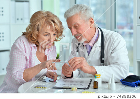 Portrait of senior doctor with elderly patient 74398306