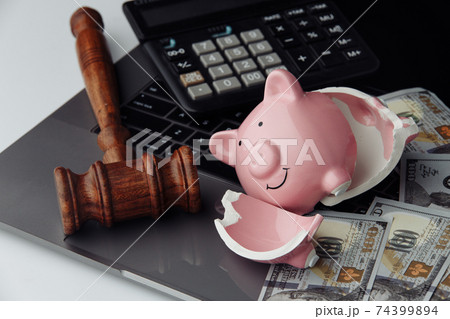 Broken piggy bank, cash and wooden gavel on keyboard. Business and bankruptcy concept Broken piggy bank, cash and wooden gavel on keyboard. Business and bankruptcy concept 74399894