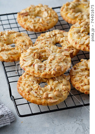 Cookies with peanuts on a black wire rack. Selective focus, closeup. Cookies with peanuts on a black wire rack. Selective focus, closeup. 74401675