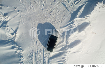 One car parked at snow field One car parked at snow field 74402635