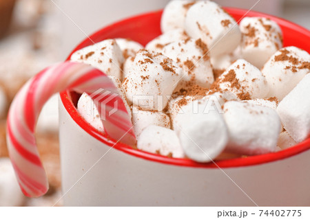 sweet food top view background for merry christmas or new year holiday decoration - chocolate candies, tangerines, cookies, marshmallow and cocoa latte on white wood 74402775