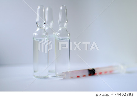 Medical ampoules and insulin syringe isolated on white background, vaccination concept 74402893