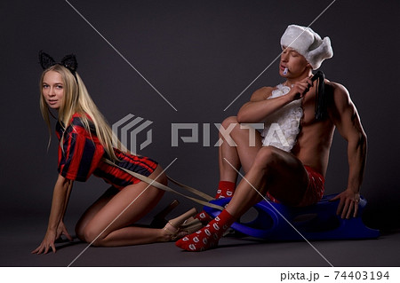 Couple in erotic Xmas costumes enjoying BDSM game Couple in erotic Xmas costumes enjoying BDSM game 74403194