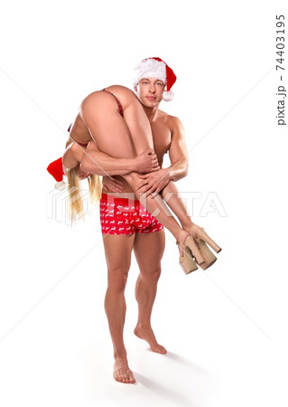 Sexy couple in erotic Xmas costumes having fun 74403195
