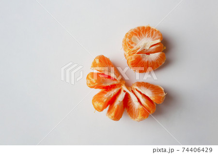 Peeled mandarin orange slices isolated on white background with a copy space 74406429