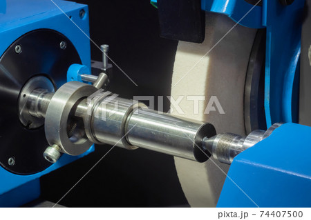 Surface grinding wheel machine working with metal workpiece at factory Surface grinding wheel machine working with metal workpiece at factory 74407500