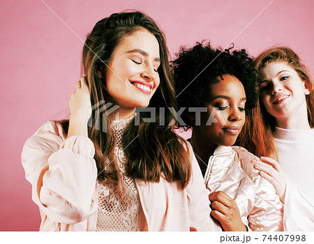 different nation girls with diversuty in skin, hair. Asian, scandinavian, african american cheerful emotional posing on pink background, woman day celebration, lifestyle people concept 74407998