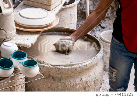 Barrel filled with mix for the clay injection molding technique in a traditional ceramics factory at the small city of Raquira in Colombia 74411825