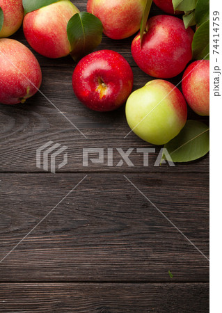 Ripe garden apple fruits on wooden table Ripe garden apple fruits on wooden table 74414759