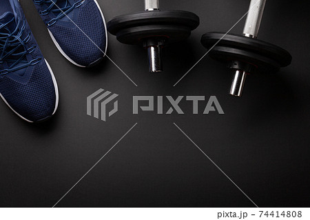 Sneakers and dumbbells. Sport, fitness and healthy lifestyle 74414808