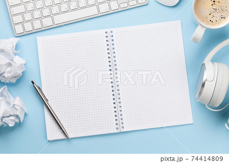Office desk with supplies, coffee and blank notepad 74414809