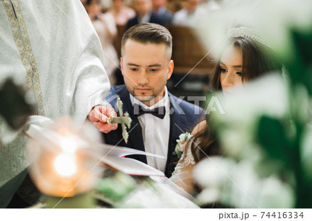 Wedding couple bide and groom get married in a church Wedding couple bide and groom get married in a church 74416334