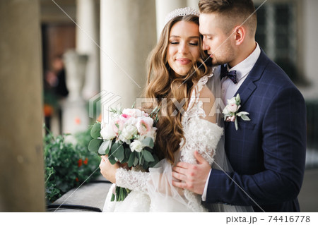 Romantic wedding moment, couple of newlyweds smiling portrait, bride and groom hugging Romantic wedding moment, couple of newlyweds smiling portrait, bride and groom hugging 74416778