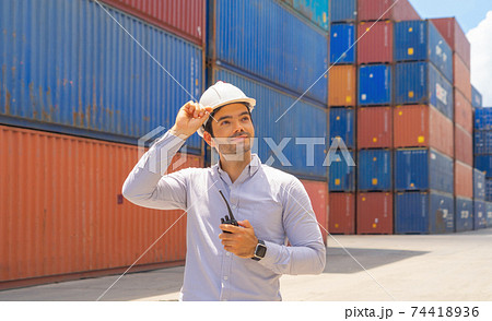Middle east logistic worker engineer man working in cargo container warehouse industry factory site in export, import, and transportation concept. Business people lifestyle. Distribution service. Middle east logistic worker engineer man working in cargo container warehouse industry factory site in export, import, and transportation concept. Business people lifestyle. Distribution service. 74418936