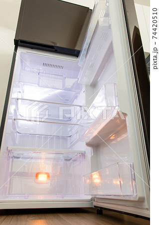 A open fridge in the kitchen. Empty clean refrigerator. 74420510