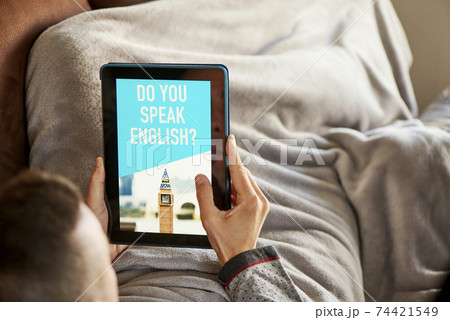 man and tablet that reads do you speak english 74421549