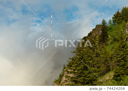 View along the ridge towards Rigi, a mountain in Switzerland, partly in clouds 74424209