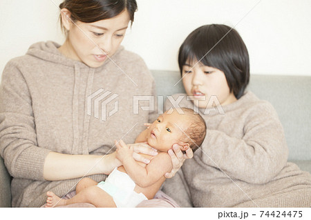 赤ちゃんを見守るお姉ちゃん 74424475