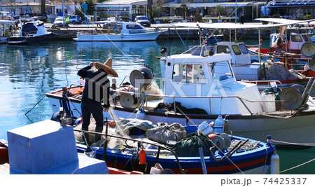 Authentic fisherman working on his nets on the boat 74425337