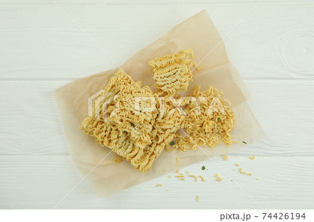 Baking paper with instant noodles on white wooden background 74426194