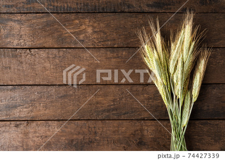 Ears of rye on wooden table with copyspace 74427339