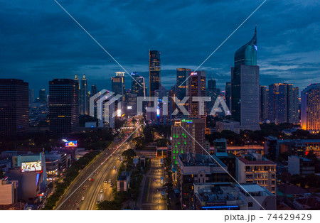 Night aerial wide view of skyscrapers and multi lane highway in large urban city center Cityscape of high rise buildings in Jakarta, Indonesia at night Night aerial wide view of skyscrapers and multi lane highway in large urban city center Cityscape of high rise buildings in Jakarta, Indonesia at night 74429429
