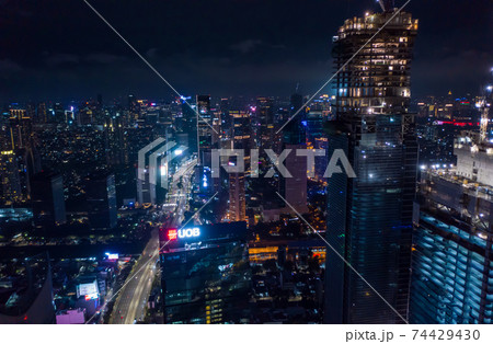 Close up aerial view of high rise skyscraper under construction in modern city center at night Tall skyscrapers in downtown Jakarta, Indonesia Close up aerial view of high rise skyscraper under construction in modern city center at night Tall skyscrapers in downtown Jakarta, Indonesia 74429430