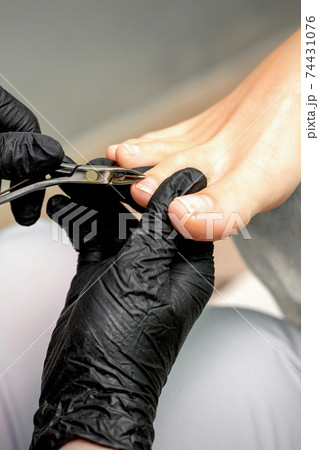 Pedicure master is cutting cuticle Pedicure master is cutting cuticle 74431076