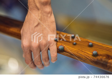 Hand touching footbridge railing handrail, risk to contaminated with germs virus bacteria and pathogen. Covid-19 disease coronavirus outbreak concept 74436676