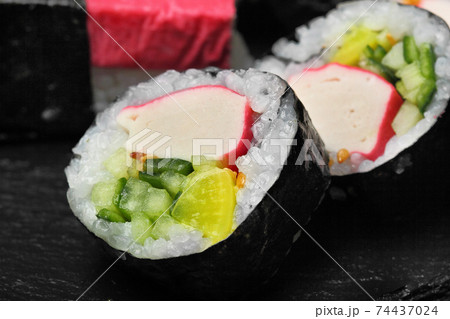 Japanese sushi makki with cucucmber and crab sticks closeup.Macro view. Japanese sushi makki with cucucmber and crab sticks closeup.Macro view. 74437024