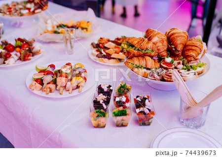 snacks in a white plate on the table for the banquet. snacks in a white plate on the table for the banquet. 74439673