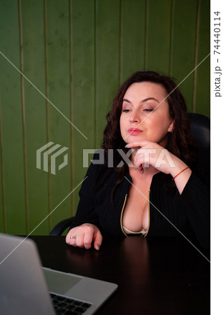 A woman with a neckline communicates in a video chat with a man and flirts 74440114