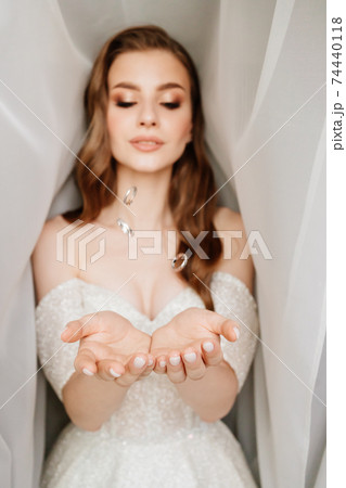 wedding rings are tossed and fall into hands of the bride. exchange of rings wedding rings are tossed and fall into hands of the bride. exchange of rings 74440118