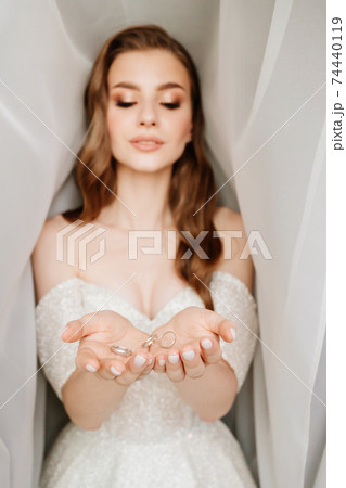 wedding rings are tossed and fall into hands of the bride. exchange of rings wedding rings are tossed and fall into hands of the bride. exchange of rings 74440119