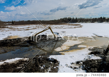 Specialized excavator cleans lake sediments of lake bottom 74440460