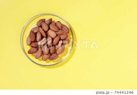 Heap of almonds on plate Heap of almonds on plate 74441246