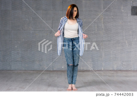 Young beautiful girl posing on studio background. Young beautiful girl posing on studio background. 74442003