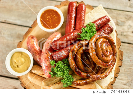 Down view on sausage assortmet with garnish. Down view on sausage assortmet with garnish. 74443348