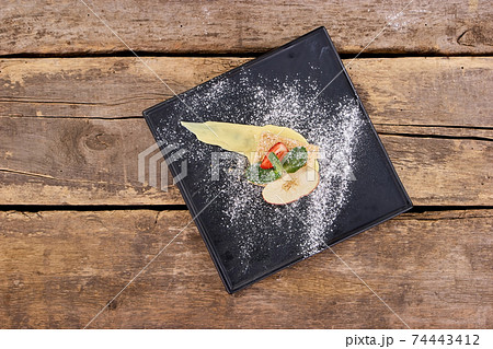 Top view cake with apple, strawberry, mint and white flour. 74443412