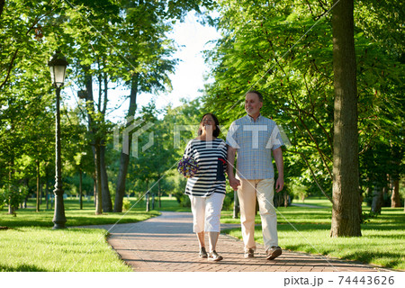 Happy smiling mature couple walks in the park. 74443626