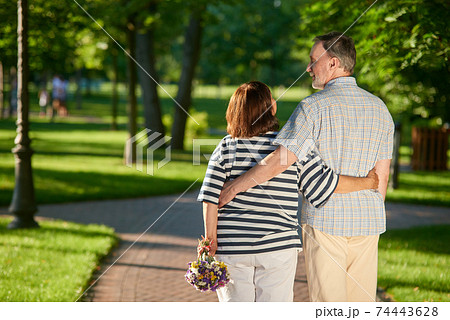 Back view mature couple in the park. Back view mature couple in the park. 74443628